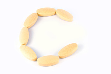 Fototapeta na wymiar C letter from c vitamin tablets isolated on white background