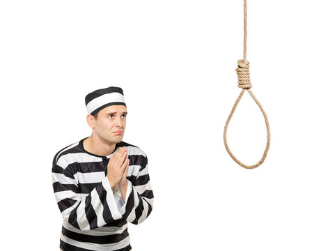 Sad prisoner in begging gesture with a noose