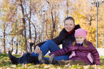 Fototapeta premium mother with daughter in autumn park