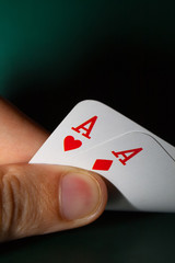 Fingers holding winning cards