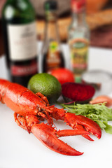 lobster against the background of vegetables and bottle of vine