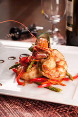 Delicatessen dish with tiger shrimps, mussels and vegetables