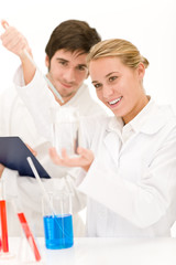 Scientists in laboratory with chemicals