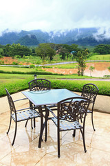 dining table surround by mist lake and mountains