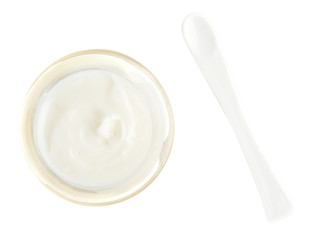 Face cream and scoop isolated on white