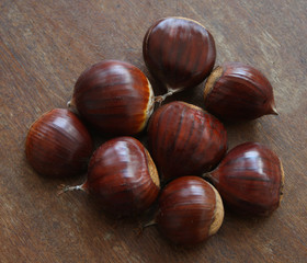 chestnuts just picked up on wooden table