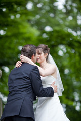 lovely young wedding couple - freshly wed groom and bride posing