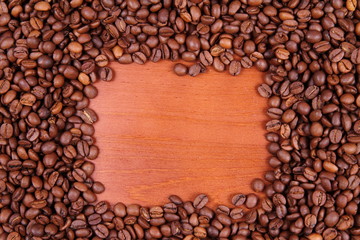 Coffee beans with wooden background with space for text