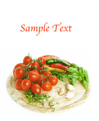 tomatoes, pepperoni, garlic and herbs on wooden board