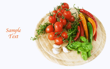 tomatoes, pepperoni, garlic and herbs on wooden board
