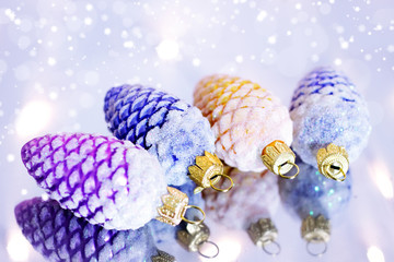Four decorative pine cones and snowflakes