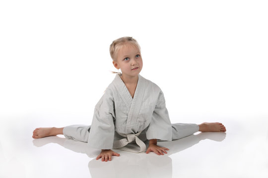 girl - karateka in a kimono on a white background