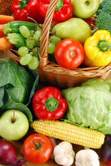 Composition with vegetables and wicker basket on kitchen table
