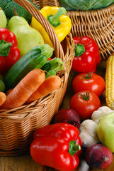 Composition with vegetables and wicker baskets on kitchen table