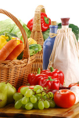 Composition with basket and vegetables on kitchen table