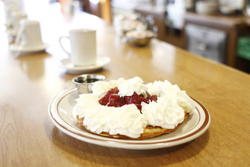 Strawberry waffle with lots of whip cream and syrup
