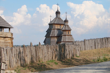 wooden stockade and a church