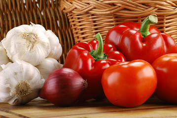 Composition with basket and vegetables on kitchen table