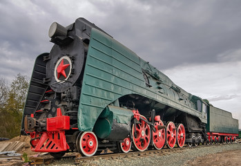 Ancient steam locomotive on white background