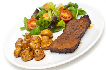 roastbeef muchrooms and salad on a white background