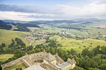 Gothic castle in Slovakia against mountain landscape.