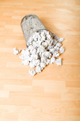 Obraz na płótnie Canvas Garbage bin with paper waste isolated on white
