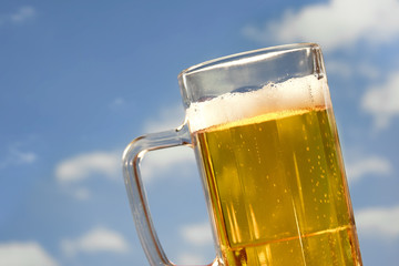 refreshing beer mug on sky background