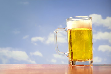 refreshing beer mug on sky background