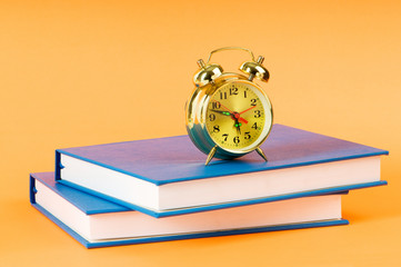 Back to school concept with books and clock