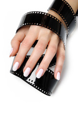 Beautiful hand with perfect nail pink manicure and photo film. i