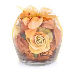 Dry flowers inside transparent glass bowl isolated on white back