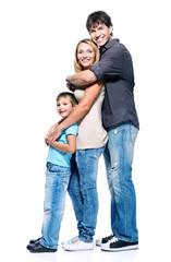 Full portrait of happy family with child standing on white