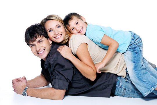 Happy beautiful family with child lying on floor