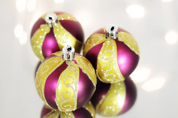 Three red Christmas ball on a background of lights