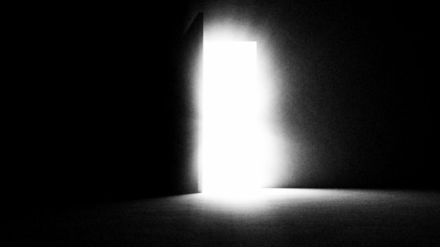 A black door opening and letting in white light.