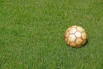 Fototapeta premium old football on fresh green grass