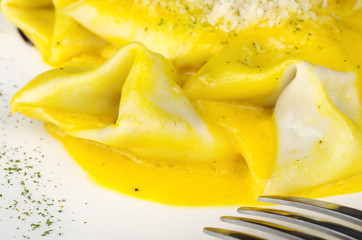 Ravioli served with grated cheese with fork