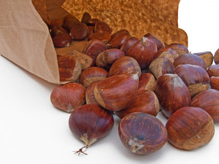 Chestnuts spilling from a paper bage