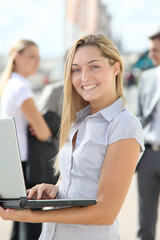 Blond businesswoman with laptop computer