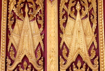 Buddhist art carving and painting on door of temple
