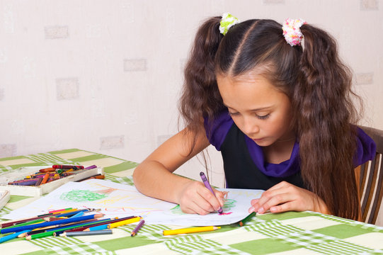 Girl drawing with crayons