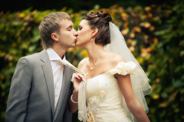Portrait of kissing newlyweds
