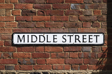 Fototapeta na wymiar Middle Street sign on brick wall. England