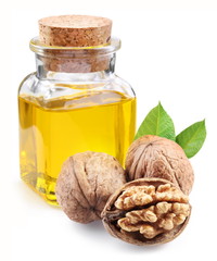 walnut oil and nuts on white background.