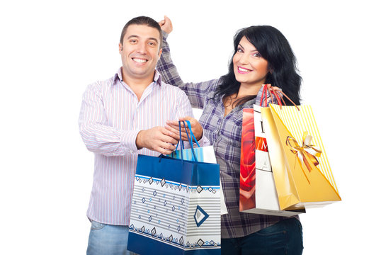 Couple with shopping bags cheering