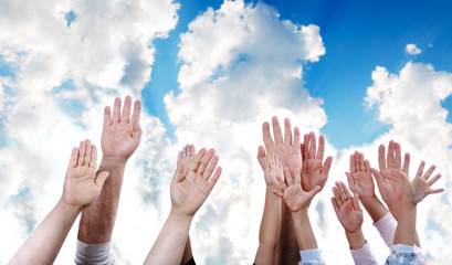 Many hands rising the sky together, children and adults