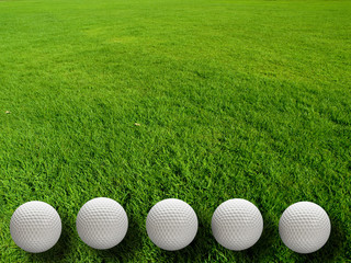 Golf balls on the grass background .
