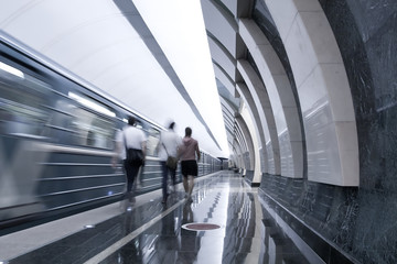 moving train and persons in metro station