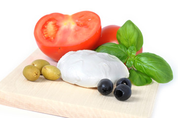 mozarella cheese with basil, tomato and olives isolated on white