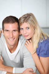 Smiling couple standing in home kitchen